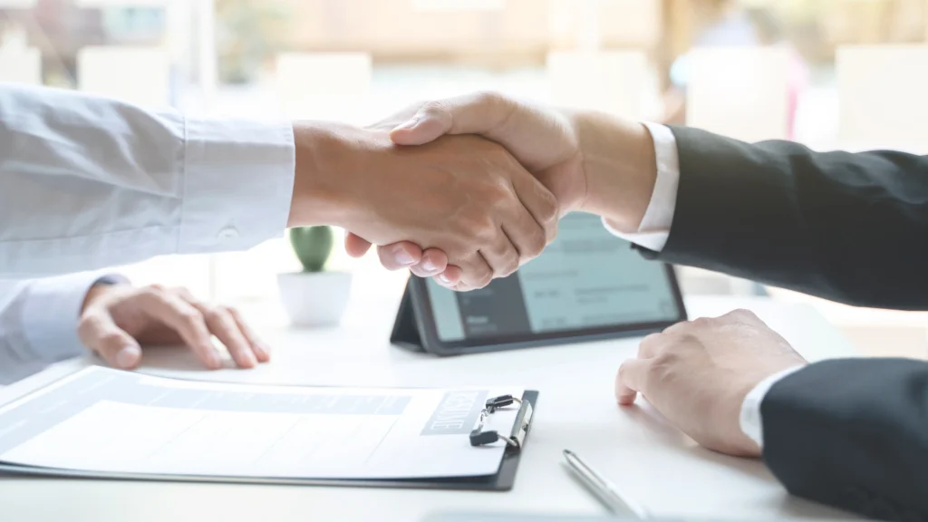 Close-up of a handshake between two professionals during a career consultation, symbolizing Vetucore LLC's commitment to connecting aspiring veterinarians with expert vet med consultants for personalized academic and career guidance.