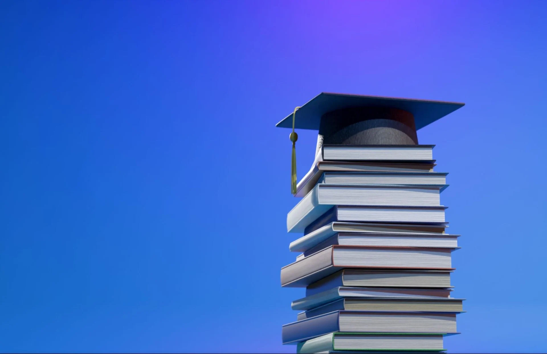 Stack of books with a graduation cap on top, symbolizing veterinary medicine education and academic success.