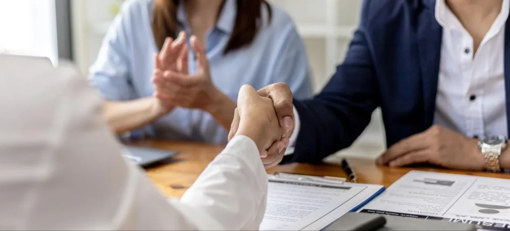 Successful vet school application interview handshake with Vetucore LLC, veterinary consulting experts for VMCAS applications.