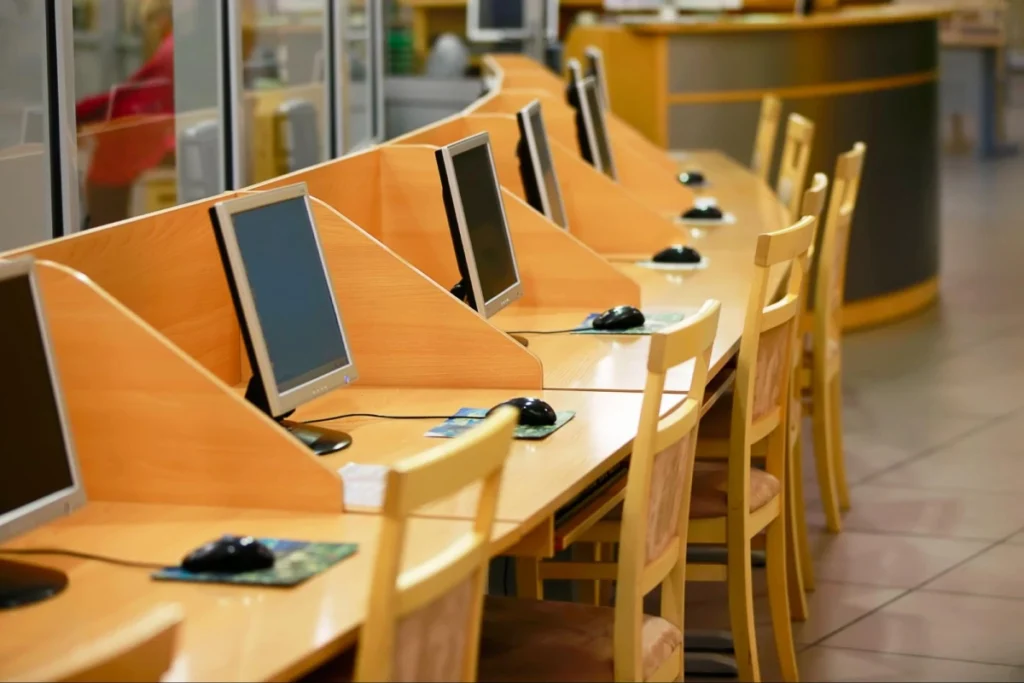 Row of computer workstations in a quiet study or application center, ideal for students researching veterinary medicine schools or completing their vet school applications. Vetucore LLC helps future veterinarians streamline the process.